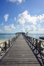 Endless jetty to the horizon; view to a turquoise sea and blue s Royalty Free Stock Photo