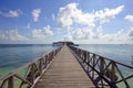 Endless jetty to the horizon; view to a turquoise sea and blue s Royalty Free Stock Photo