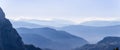 Endless mountain ranges of the Dolomites covered in morning mist. View from Seiser Alm plateau