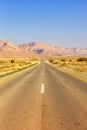 Endless road driving drive empty desert landscape portrait format loneliness infinite Royalty Free Stock Photo