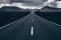 Endless road on a volcano in Timanfaya National Park in Lanzarote in the Canary Islands with a continuous line, black