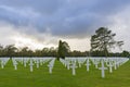 Endless rows of white crosses under a spectacular cloudy sky at the impressive American military cemetery near Colleville-sur-Mer