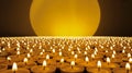 An endless sea of candles with a giant light source in the background Royalty Free Stock Photo
