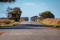 Endless straight road in Australian Outback with hot sun causing a Fata Morgana