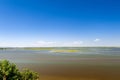 Endless summer landscape. Lake, forest and clear blue sky with beautiful little clouds. Royalty Free Stock Photo