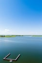 Endless summer landscape. Lake, forest and clear blue sky with beautiful little clouds. Royalty Free Stock Photo