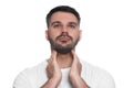 Endocrine system. Man doing thyroid self examination on white background Royalty Free Stock Photo