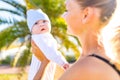 Endorphin oxytocin hormone feeling of mother to her cute baby outdoors in tropical beach