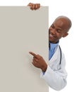Endorsing your healthcare message. A young african doctor pointing to an area reserved for copyspace.