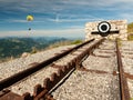 Endpoint of a rack railway on the top of a mountain with a paraglider in the background Royalty Free Stock Photo