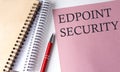 ENDPOINT SECURITY word on the pink paper with office tools on white background