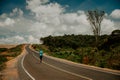 Endurance runner running on asphalt road in African nature. Marathon training in Kenya Royalty Free Stock Photo