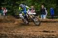 Enduro bike rider accelerating in dirt track