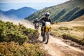 Enduro bikers crossing road in Carpathian mountains.