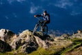 Enduro Cyclist Riding the Bike on the Rock at Night. Extreme Sport Concept. Space for Text. Royalty Free Stock Photo