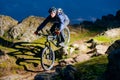 Enduro Cyclist Riding the Bike on the Rocky Trail at Night. Extreme Sport Concept. Space for Text. Royalty Free Stock Photo