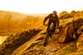 Enduro Cyclist Riding the Mountain Bike Down Beautiful Rocky Trail. Extreme Sport Concept. Space for Text.