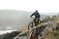 Enduro Cyclist Riding the Mountain Bike Down Beautiful Rocky Trail. Extreme Sport Concept. Space for Text. Royalty Free Stock Photo