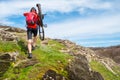 Enduro Cyclist Taking his Mountain Bike up to Beautiful Rocky Trail. Extreme Sport and Adventure Concept.