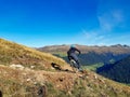 Enduro ride with steep bend, banked curve, Swiss Mountain Alps at Davos Switzerland. With blue clear sky and great view