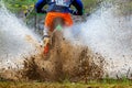 Enduro Motocross mud,Motocross racer in a wet and muddy terrain covering the driver completely. Royalty Free Stock Photo