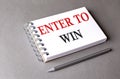 ENER TO WIN word on notebook on grey background Royalty Free Stock Photo