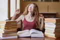 Energetic attractive ÃÂute student stretching herself after sitting on chair for long period of time, having hard working day, Royalty Free Stock Photo