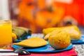 An energetic breakfast contain orange juice, empanada and bolon served on a blue plate, traditional andean food concept