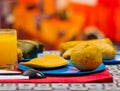 An energetic breakfast contain orange juice, empanada and bolon served on a blue plate, traditional andean food concept