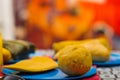 An energetic breakfast contain orange juice, empanada and bolon served on a blue plate, traditional andean food concept