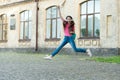 Energetic child girl jumping dancing listening music headphones, never stop concept