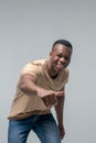 Energetic dark skinned man gesturing with hand forward Royalty Free Stock Photo