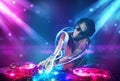 Energetic Dj mixing music with powerful light effects Royalty Free Stock Photo