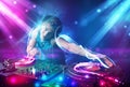 Energetic Dj mixing music with powerful light effects