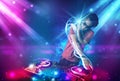 Energetic Dj mixing music with powerful light effects