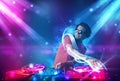 Energetic Dj mixing music with powerful light effects