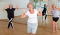 Energetic elderly woman practicing vigorous dance movements