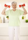 Energetic elderly woman training at home