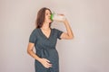 Energetic and fit pregnant woman after 40 enjoying a protein shake for a nourishing boost during her pregnancy journey Royalty Free Stock Photo