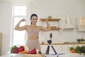 Energetic fitness blogger filming vlog on vegetarian diet and healthy eating habits