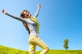 Energetic girl with open arms outdoors.