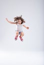 Energetic little girl jumping high into the air Royalty Free Stock Photo