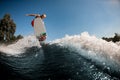 Energetic man jumping high on wave on surf style wakeboard Royalty Free Stock Photo