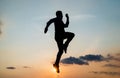 energetic man runner silhouette running to future against sunset sky, success