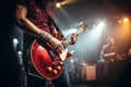 Energetic music band performing live on concert stage with blurred background and guitarist in focus Royalty Free Stock Photo