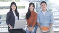 Energetic optimistic teen people and business woman sit and smile on bench outdoor public