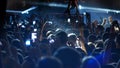 Energetic people dancing with their hands up at the punk concert - blue lighting Royalty Free Stock Photo