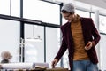 Energetic pleasant fashionably worn manager looking at office desk