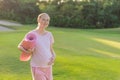 Energetic pregnant woman takes her workout outdoors, using an exercise mat for a refreshing and health-conscious outdoor Royalty Free Stock Photo