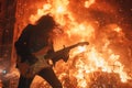 Energetic Rockstar Performing on Stage with Fiery Guitar Solos and Captivating Audience